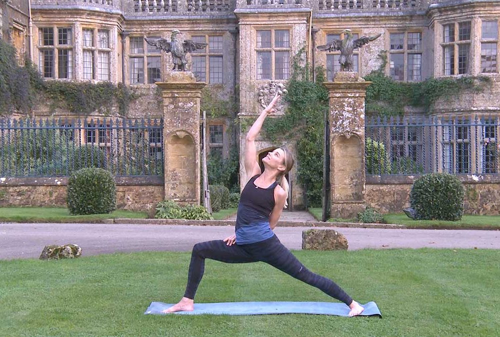 Julie practising yoga in front of Mapperton House